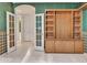 Cozy room featuring decorative walls, built-in shelving, and an open doorway to additional rooms at 15377 W Catalina Ct, Goodyear, AZ 85395