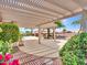 A covered patio area is a welcome respite from the sun, with views of mature landscaping and a private pool at 15377 W Catalina Ct, Goodyear, AZ 85395