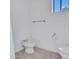 Minimalist powder room with a bidet, toilet, and neutral tile flooring at 15377 W Catalina Ct, Goodyear, AZ 85395