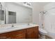 Well-lit bathroom featuring double sinks, large mirror, and a shower-tub combination at 15910 W Fillmore St, Goodyear, AZ 85338