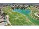 Community aerial view of golf course with a serene lake, landscaping, and nearby residences at 16250 S 13Th St, Phoenix, AZ 85048