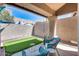 Covered patio with seating area and putting green with blue patio furniture at 16250 S 13Th St, Phoenix, AZ 85048