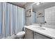 Bathroom with a tub and shower featuring a blue striped curtain and neutral colored walls at 16250 S 13Th St, Phoenix, AZ 85048