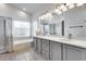 Bathroom featuring double sinks, large counter space, and a window for natural light at 16250 S 13Th St, Phoenix, AZ 85048
