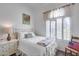 Cozy bedroom with a white metal bed frame and a window with bright light at 16250 S 13Th St, Phoenix, AZ 85048
