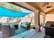 Inviting covered patio with comfortable seating, BBQ grill, and stylish decor for outdoor relaxation at 16250 S 13Th St, Phoenix, AZ 85048