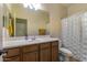 Bathroom featuring a vanity, toilet, and shower with a white curtain at 16559 W Lincoln St, Goodyear, AZ 85338