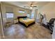 A bedroom features a ceiling fan and neutral tones with white bedside tables at 16559 W Lincoln St, Goodyear, AZ 85338