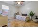 Bedroom featuring a bed, ceiling fan, and side table on light colored tile at 16559 W Lincoln St, Goodyear, AZ 85338