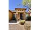 Charming front entrance featuring stone accents, covered entryway, and well-maintained landscaping at 16559 W Lincoln St, Goodyear, AZ 85338