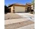 Attractive home exterior showcasing a two-car garage, desert landscaping, and a well-maintained driveway at 16559 W Lincoln St, Goodyear, AZ 85338
