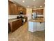 A kitchen features granite countertops, a kitchen island, and stainless steel appliances at 16559 W Lincoln St, Goodyear, AZ 85338