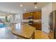 Bright kitchen with stainless appliances, island with granite counters, and modern fixtures at 16559 W Lincoln St, Goodyear, AZ 85338