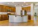 Spacious kitchen features an island, granite counters, and wood cabinets at 16559 W Lincoln St, Goodyear, AZ 85338