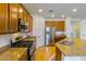 Well-equipped kitchen showcasing stainless steel appliances and a granite countertop island at 16559 W Lincoln St, Goodyear, AZ 85338