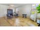 Bright living room features stylish tile floor, cabinet, chair, and large windows with shutters at 16559 W Lincoln St, Goodyear, AZ 85338