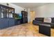 Modern living room featuring built-in cabinets, a television, and comfortable seating at 16559 W Lincoln St, Goodyear, AZ 85338