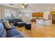 Open-concept living room with a comfortable couch and direct access to the kitchen and dining area at 16559 W Lincoln St, Goodyear, AZ 85338