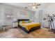 Bright main bedroom with tile floors, a ceiling fan, and large windows at 16559 W Lincoln St, Goodyear, AZ 85338