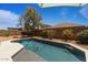 Backyard pool is perfect for summer relaxation, surrounded by desert landscaping and privacy fence at 16559 W Lincoln St, Goodyear, AZ 85338