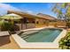 Backyard pool surrounded by landscaping, patio and the exterior of the home at 16559 W Lincoln St, Goodyear, AZ 85338