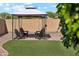 Outdoor space with stylish seating under a gazebo on artificial turf and desert landscaping at 1718 E Harwell Rd, Phoenix, AZ 85042