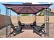 Charming backyard featuring a covered seating area with stylish Adirondack chairs at 1718 E Harwell Rd, Phoenix, AZ 85042