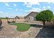 Expansive backyard featuring artificial grass, a fire pit, and desert landscaping at 1718 E Harwell Rd, Phoenix, AZ 85042