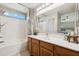 Well-lit bathroom with a vanity, mirror, and shower-tub combination at 1718 E Harwell Rd, Phoenix, AZ 85042