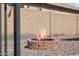 Backyard fire pit with a brick surround and desert landscaping at 1718 E Harwell Rd, Phoenix, AZ 85042