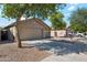 Suburban home featuring desert landscaping, a spacious driveway, and an attached two-car garage at 1718 E Harwell Rd, Phoenix, AZ 85042