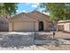 Charming single-story home with a well-maintained lawn, two car garage, and inviting front entrance at 1718 E Harwell Rd, Phoenix, AZ 85042