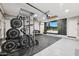 Well-equipped home gym featuring a full weight rack and entertainment setup at 1718 E Harwell Rd, Phoenix, AZ 85042