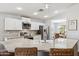 Bright, open kitchen featuring white cabinets, a large island with seating, and stainless steel appliances at 1718 E Harwell Rd, Phoenix, AZ 85042