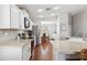 Modern kitchen featuring stainless steel appliances, white cabinets, and a breakfast bar overlooking the dining area at 1718 E Harwell Rd, Phoenix, AZ 85042