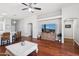 Open concept living area with hardwood floors and seamlessly connected dining and kitchen spaces at 1718 E Harwell Rd, Phoenix, AZ 85042