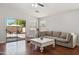 Comfortable living room with sliding doors to the backyard, hardwood floors, and relaxed seating at 1718 E Harwell Rd, Phoenix, AZ 85042