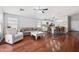 Open-concept living area with wood floors, modern furnishings, neutral color palette, and ample natural light at 1718 E Harwell Rd, Phoenix, AZ 85042