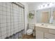 Bathroom showcasing a shower with curtain and a well-lit vanity at 17441 N Del Webb Blvd, Sun City, AZ 85373