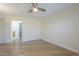Bright bedroom with light hardwood floors and a modern ceiling fan at 17441 N Del Webb Blvd, Sun City, AZ 85373