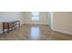 Neutral bedroom featuring wood-look floors, base trim, and a bright window at 17441 N Del Webb Blvd, Sun City, AZ 85373