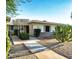 Charming single-story home with desert landscaping, complemented by mature cactus and gravel ground cover at 17441 N Del Webb Blvd, Sun City, AZ 85373
