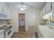 Kitchen featuring white cabinets and appliances with a view to the breakfast nook and an adjacent doorway at 17441 N Del Webb Blvd, Sun City, AZ 85373
