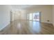 Large living room featuring wood floors, a sliding glass door, and a stylish chandelier at 17441 N Del Webb Blvd, Sun City, AZ 85373