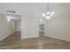 Bright living room featuring wood flooring and a stylish chandelier at 17441 N Del Webb Blvd, Sun City, AZ 85373