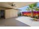 View of the covered patio featuring an epoxy floor, mural, storage shed, and ceiling fan at 17441 N Del Webb Blvd, Sun City, AZ 85373