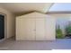 Covered patio with storage shed with double doors and epoxy flooring at 17441 N Del Webb Blvd, Sun City, AZ 85373