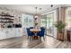 Cozy breakfast nook with a round table, blue chairs, and sliding glass doors to the patio at 17664 W Marshall Ln, Surprise, AZ 85388
