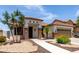 Attractive single-story home with stone accents, manicured landscaping, and tile roof at 17664 W Marshall Ln, Surprise, AZ 85388