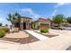 Charming single-story home with desert landscaping, stone columns, and a two car garage at 17664 W Marshall Ln, Surprise, AZ 85388